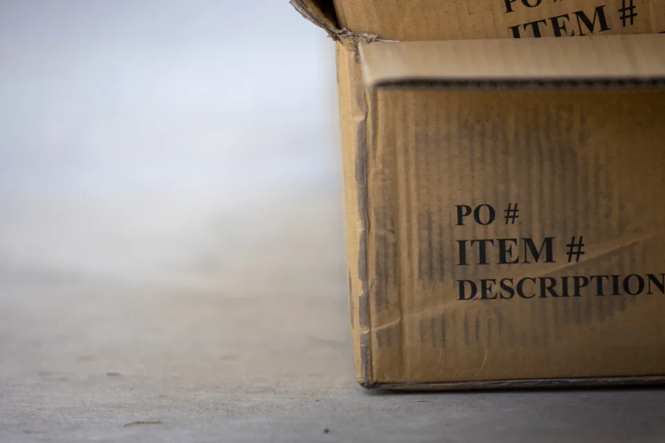 Caixa de papelão de mudança no chão, com etiqueta de item e descrição